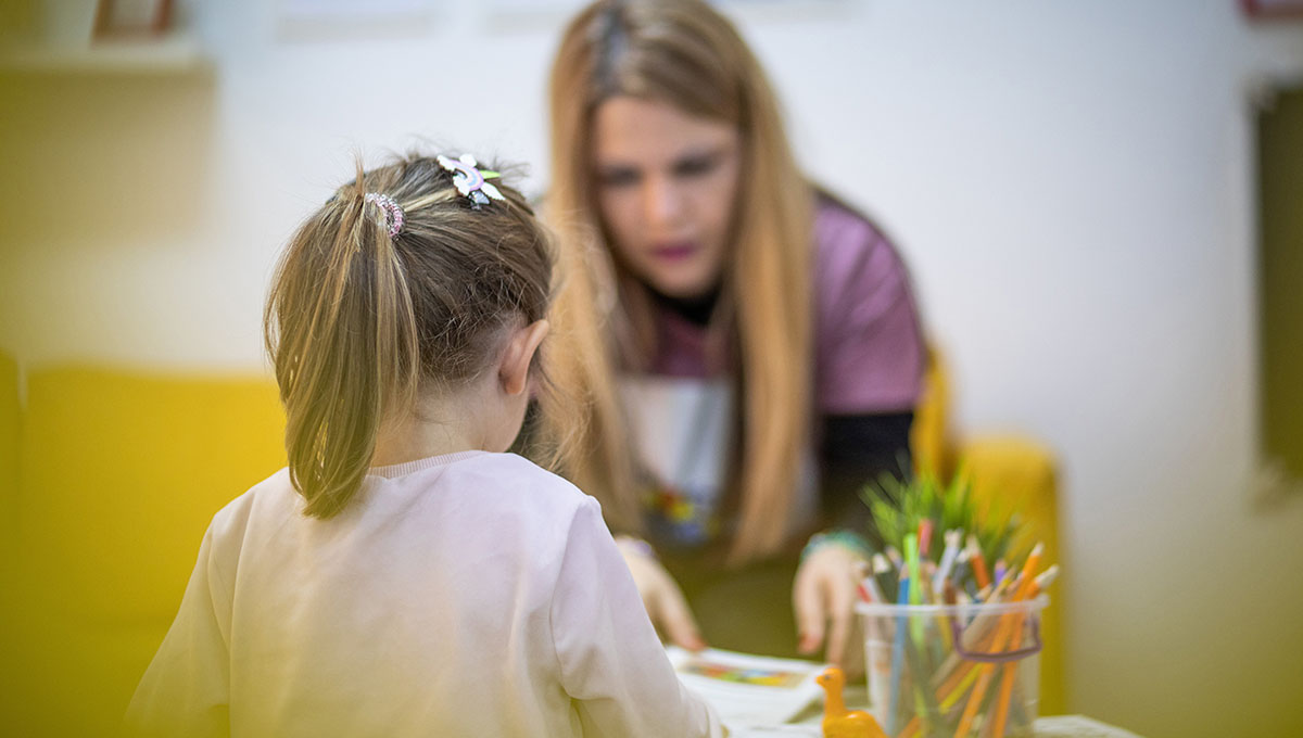 The educator works with a small child in a children's workshop